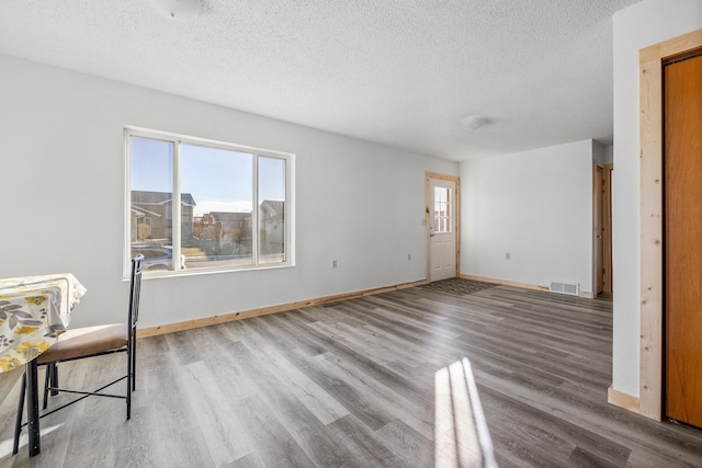 interior space with light hardwood / wood-style floors and a textured ceiling