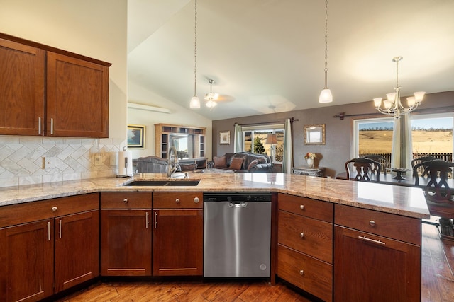 5017 Misty Woods Ln, Rapid City, SD 57701 - kitchen with dishwasher, sink, dark hardwood / wood-style flooring, pendant lighting, and vaulted ceiling