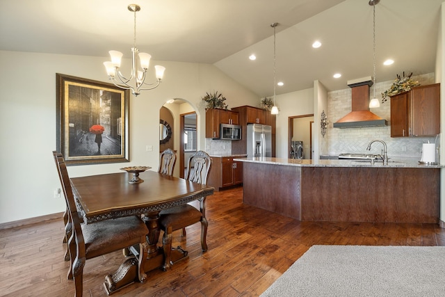 5017 Misty Woods Ln, Rapid City, SD 57701 - dining space featuring dark hardwood / wood-style flooring, an inviting chandelier, vaulted ceiling, and sink