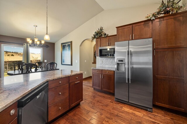 5017 Misty Woods Ln, Rapid City, SD 57701 - kitchen with lofted ceiling, dark wood-type flooring, decorative light fixtures, stainless steel appliances, and a chandelier
