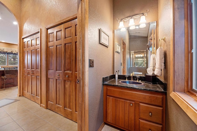 bathroom with tile patterned flooring and vanity