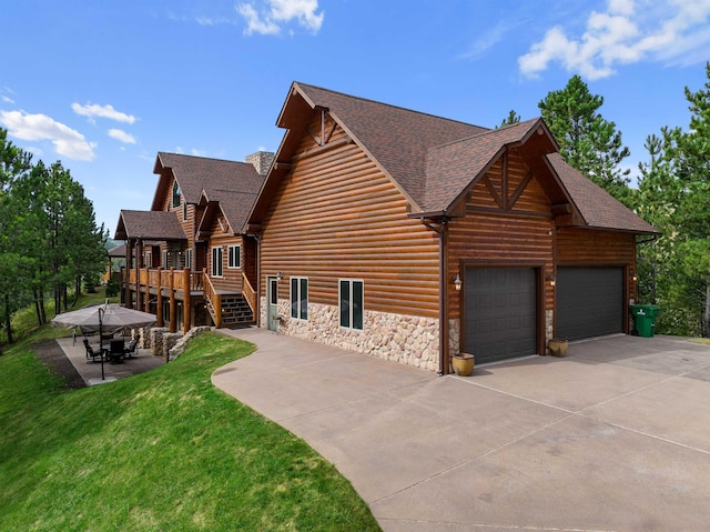 view of side of property with a yard, a patio, and a wooden deck