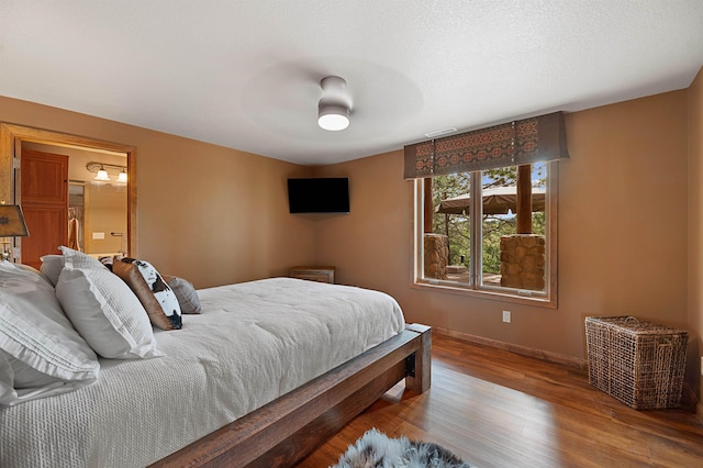 bedroom with wood-type flooring and ceiling fan