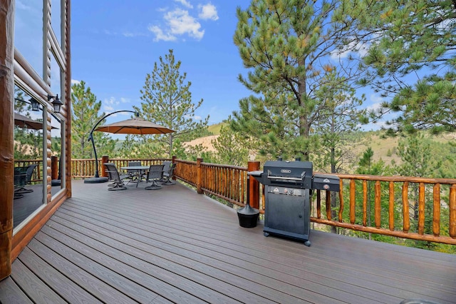 wooden terrace featuring a grill and a mountain view