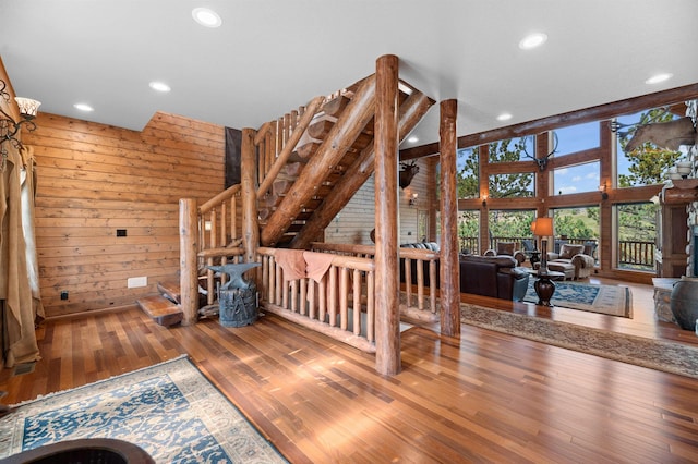 living room featuring wooden walls and hardwood / wood-style floors