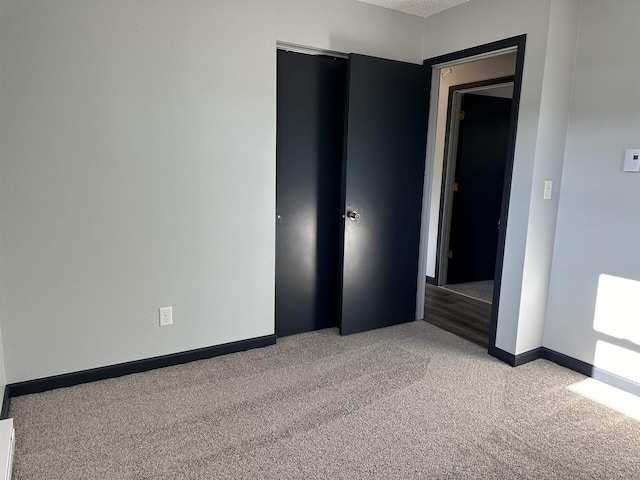 unfurnished bedroom featuring light carpet