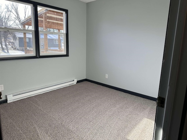 carpeted empty room with baseboard heating