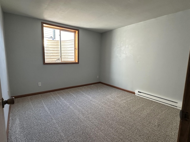 empty room featuring carpet and a baseboard radiator