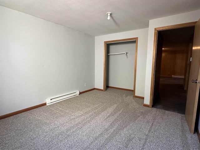 unfurnished bedroom featuring carpet, a closet, and a baseboard radiator