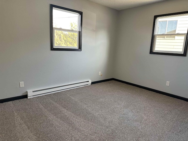 unfurnished room featuring baseboard heating, plenty of natural light, and carpet floors