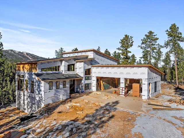 back of property featuring a mountain view