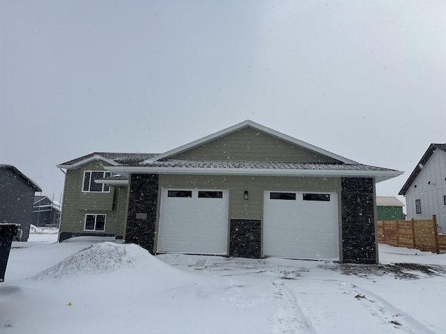 view of front facade with a garage and fence