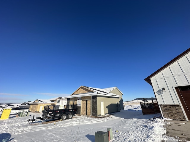 view of snowy exterior featuring an outdoor structure