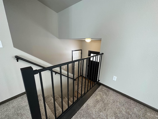 stairs featuring carpet flooring and baseboards