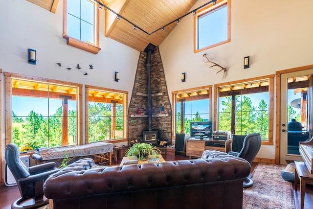 living room featuring beam ceiling, a wood stove, wooden ceiling, high vaulted ceiling, and hardwood / wood-style flooring