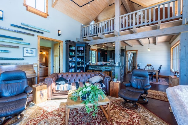 living room featuring wooden walls, high vaulted ceiling, and wood ceiling