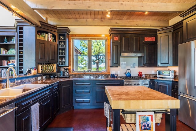 kitchen with beam ceiling, wooden ceiling, and stainless steel appliances