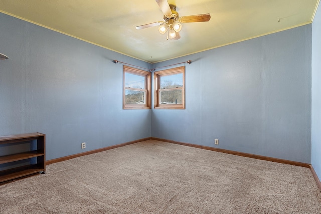 empty room featuring carpet floors, ceiling fan, and ornamental molding