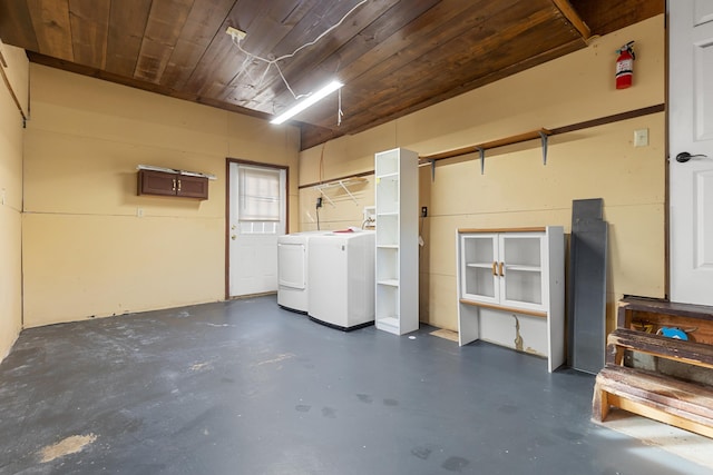 garage featuring washing machine and dryer and wooden ceiling