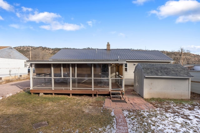 rear view of property with a shed