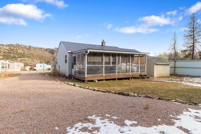 rear view of property with a shed