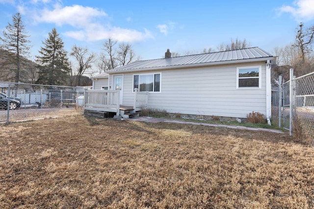 back of house featuring a yard and a wooden deck