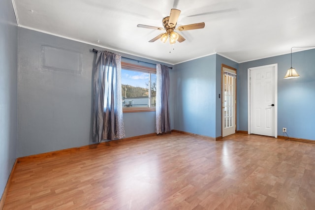 empty room featuring hardwood / wood-style floors, ceiling fan, and ornamental molding