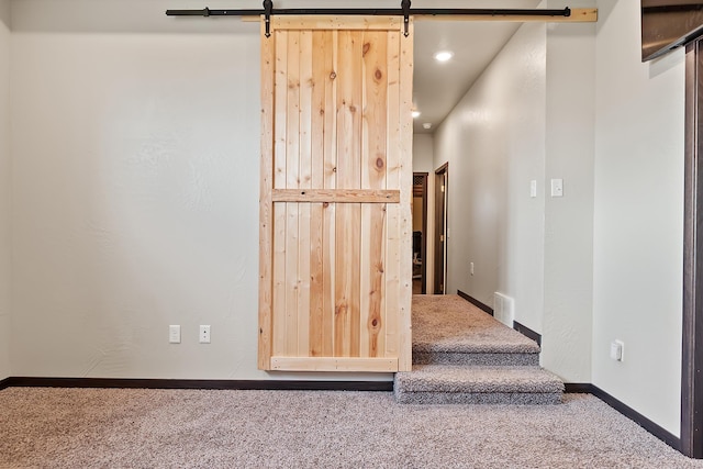 stairs featuring carpet and a barn door