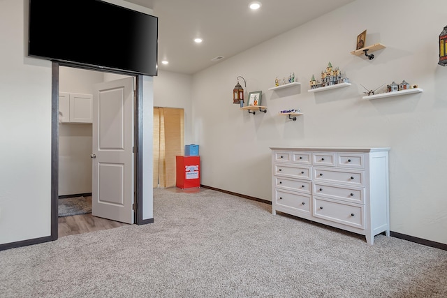 unfurnished bedroom featuring light carpet