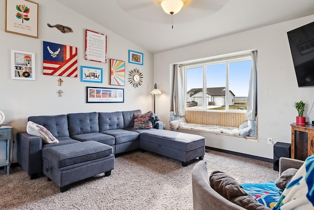 living room featuring ceiling fan, carpet flooring, and vaulted ceiling