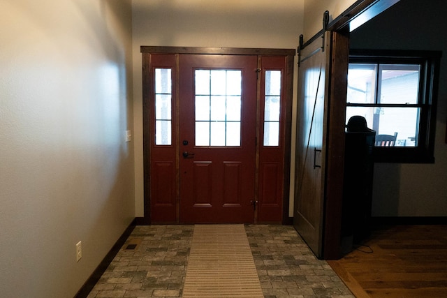 entrance foyer with dark hardwood / wood-style flooring and a barn door