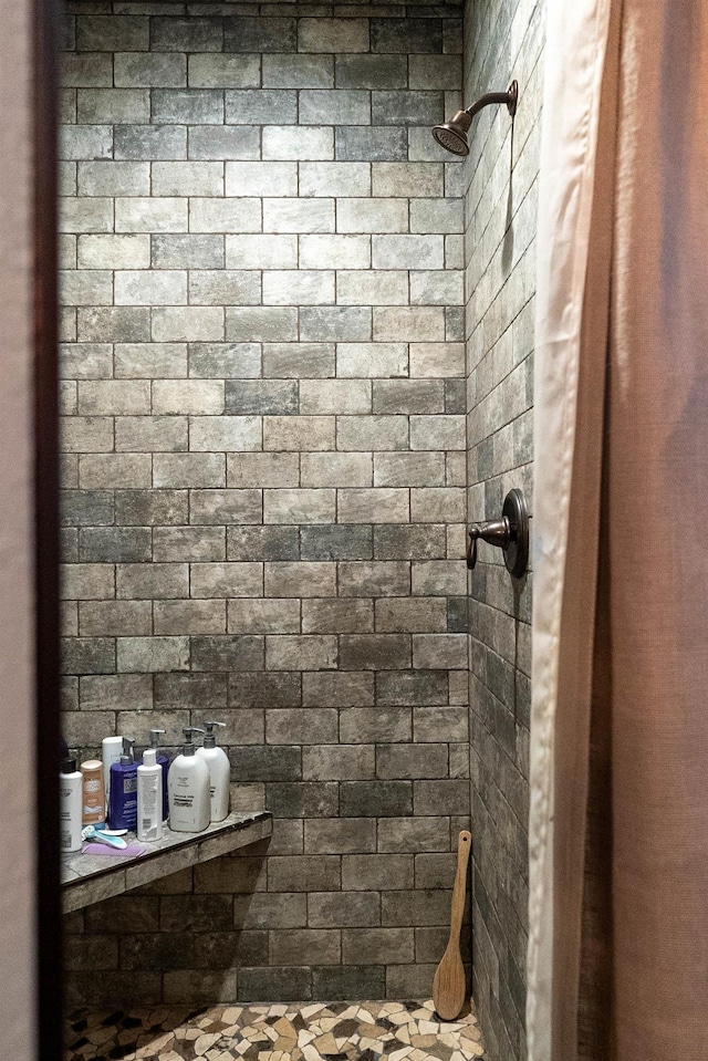 bathroom with a tile shower