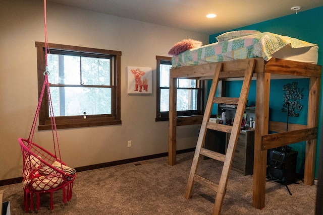 bedroom featuring carpet flooring and multiple windows