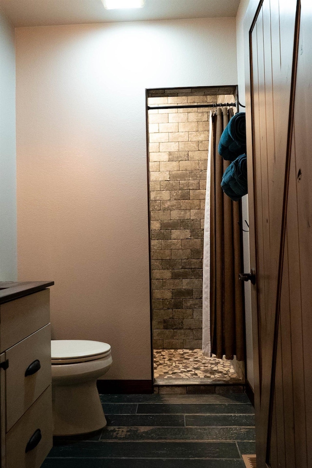 bathroom with a shower with shower curtain, vanity, toilet, and hardwood / wood-style floors