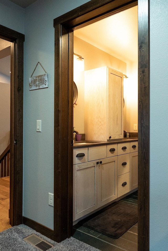 interior space with hardwood / wood-style floors and vanity