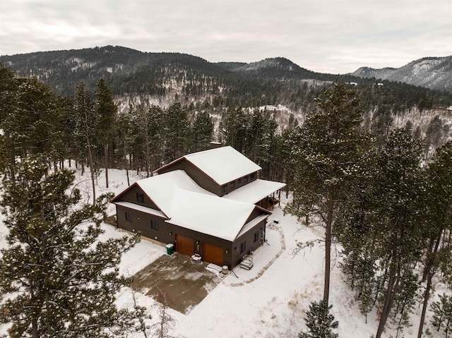 snowy aerial view featuring a mountain view