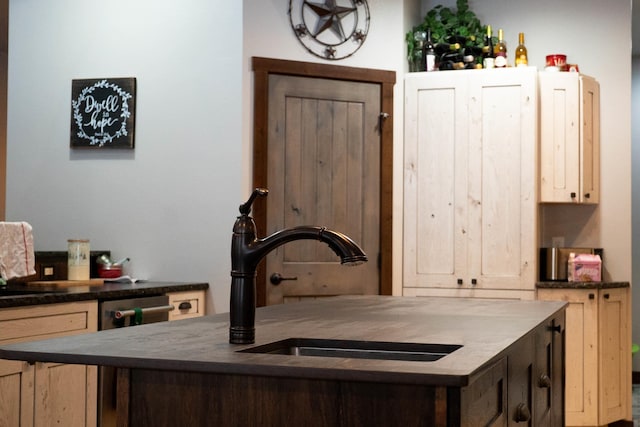 kitchen with light brown cabinetry and sink