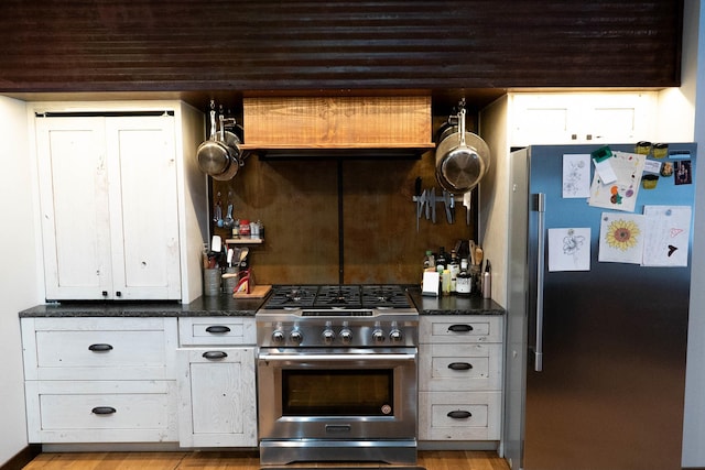 kitchen featuring white cabinets, light wood-type flooring, and stainless steel appliances