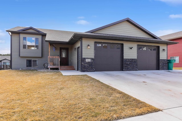 view of front of home with a front yard and a garage