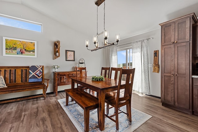 dining room featuring plenty of natural light, dark hardwood / wood-style flooring, and lofted ceiling