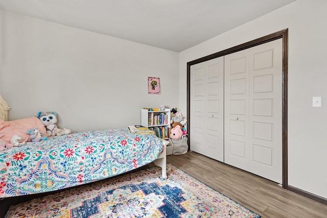 bedroom with a closet and light hardwood / wood-style flooring