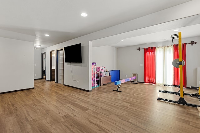 exercise room featuring hardwood / wood-style floors