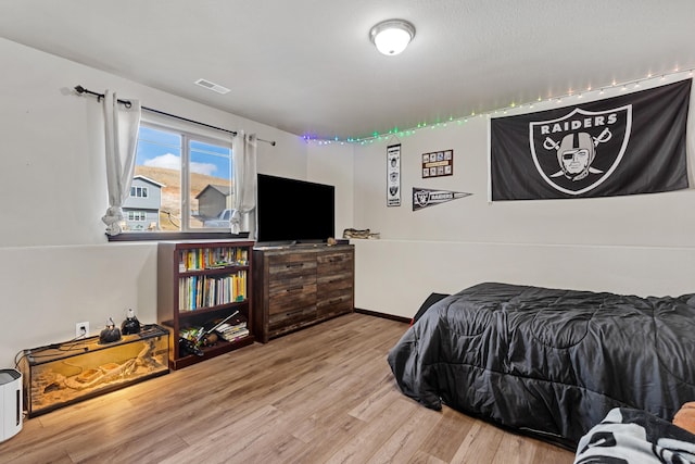 bedroom with light hardwood / wood-style flooring