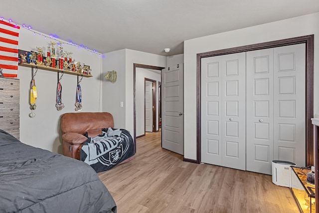 bedroom with a closet and light hardwood / wood-style flooring