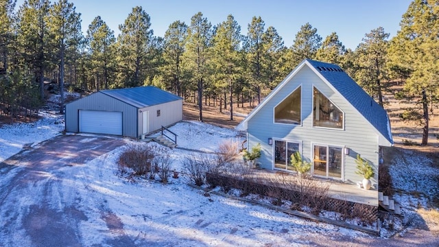 view of front of property featuring a garage and an outdoor structure