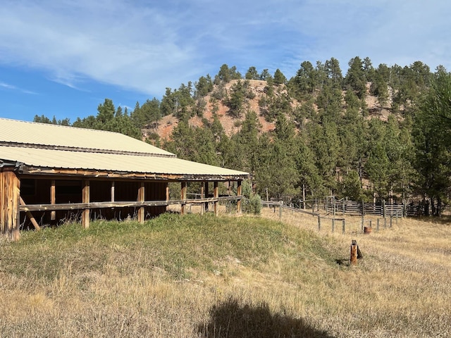 view of yard featuring a rural view and an outdoor structure