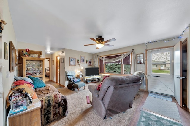 living room featuring ceiling fan and light carpet