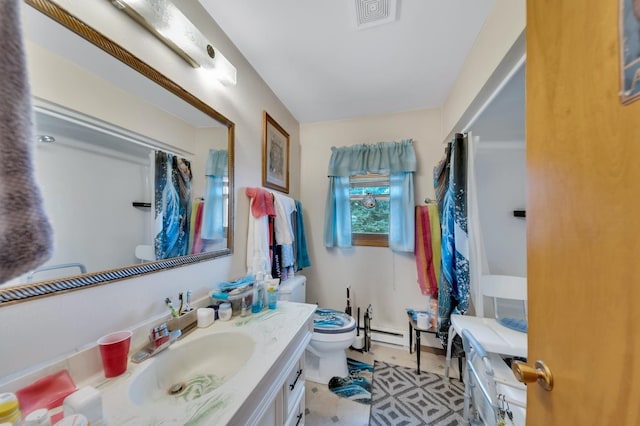 bathroom featuring tile patterned flooring, vanity, toilet, and baseboard heating
