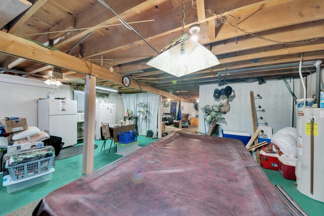 basement featuring electric water heater and white refrigerator