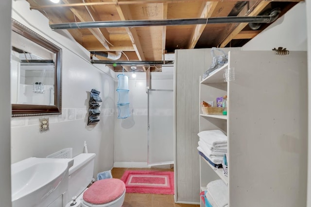 bathroom with toilet, parquet floors, and sink